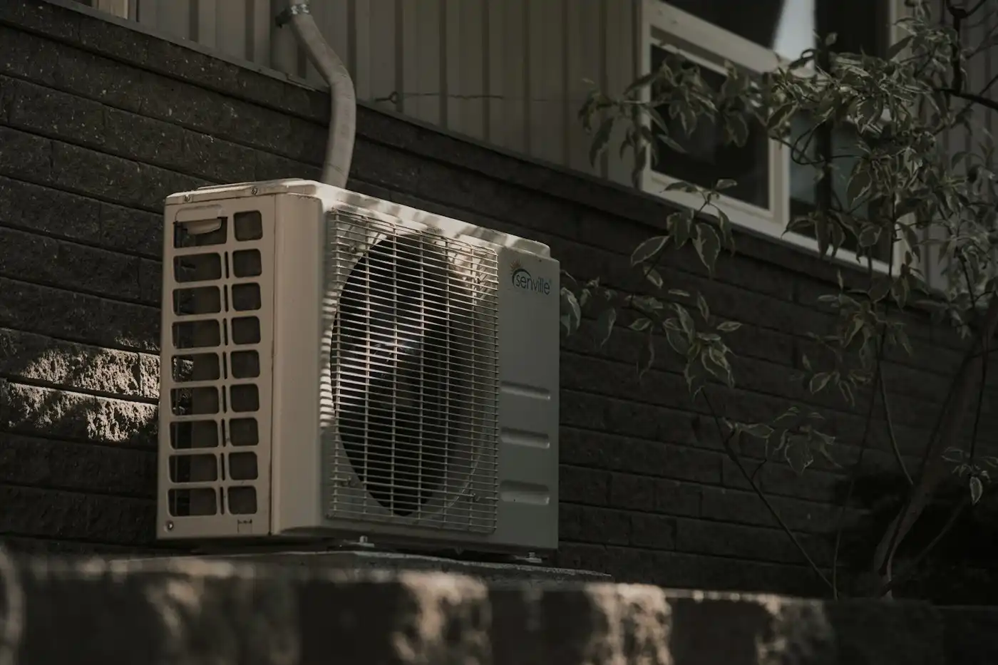 Outdoor unit mounted on a brick wall