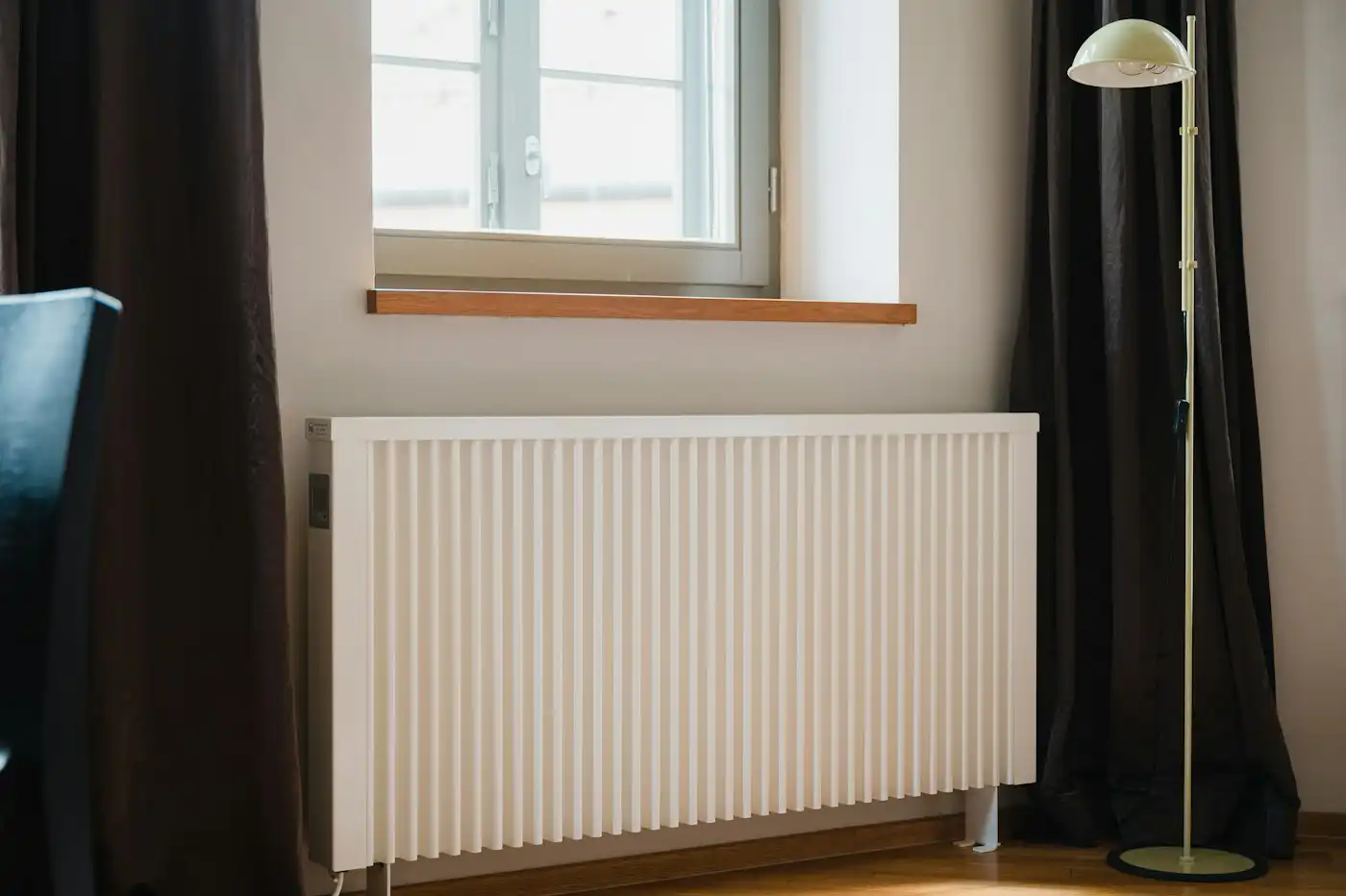 White radiator beneath a window