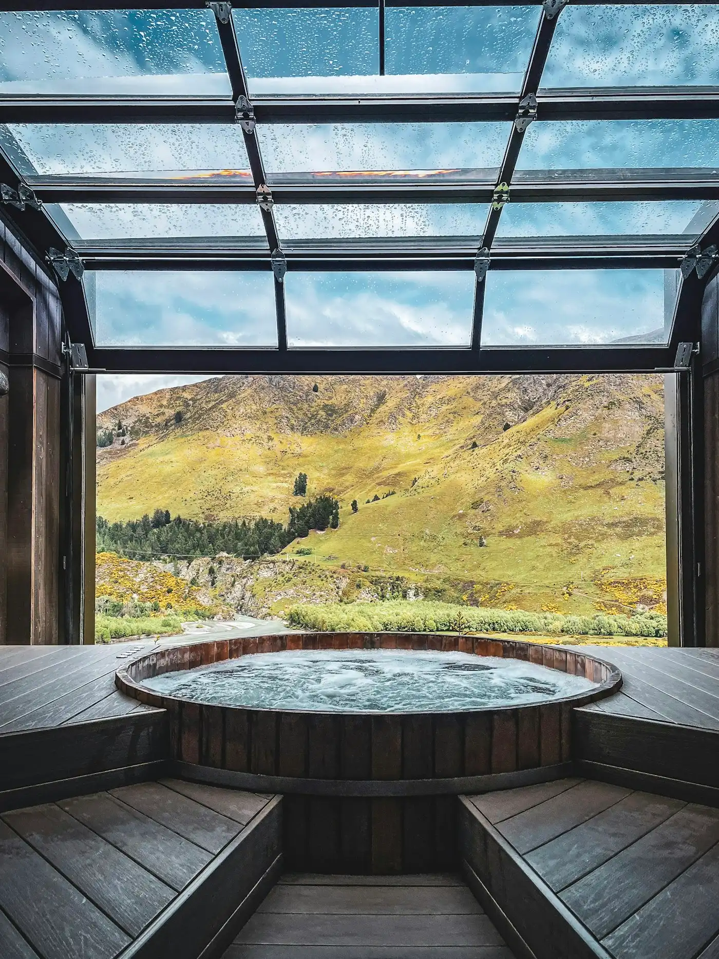 Hot tub in a room with a mountain view