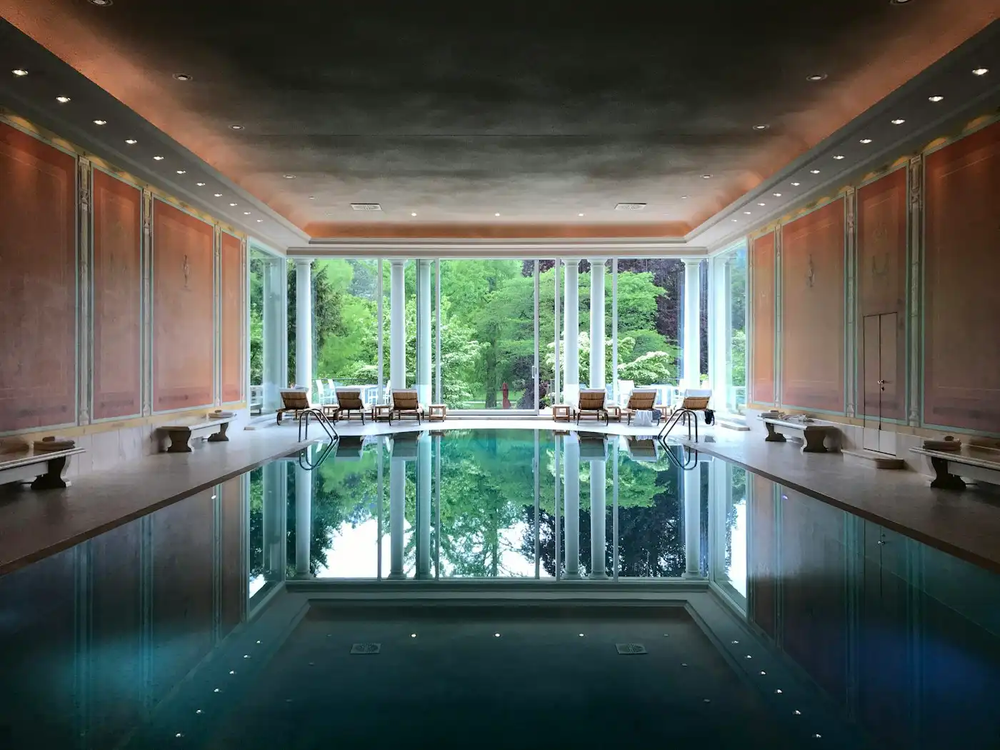 Large indoor pool with a view of trees