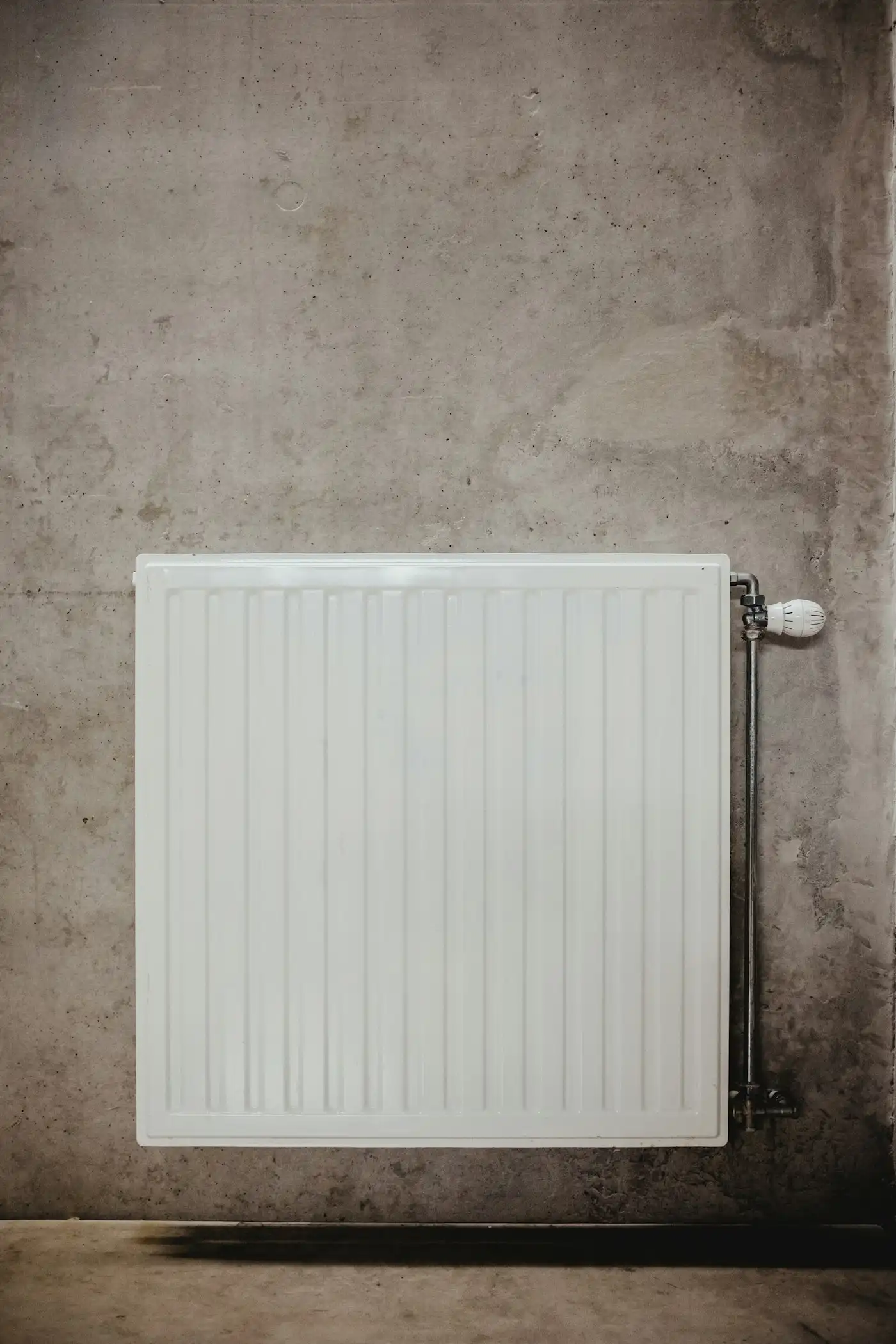 White panel heater on a concrete wall